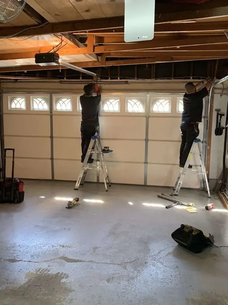 Apollo Garage Door technician repairing a garage door in Dallas